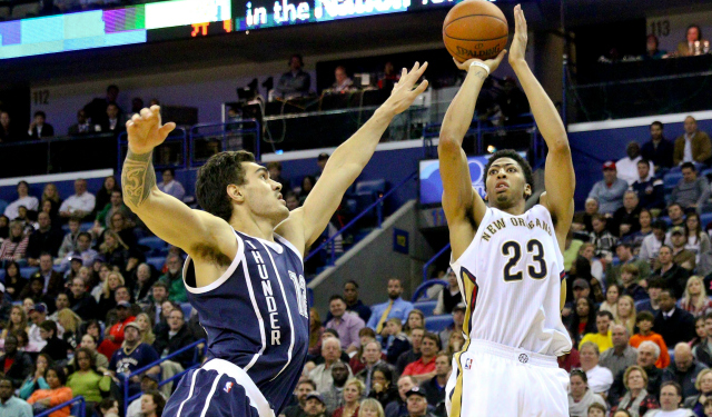 Feb 4, 2015; New Orleans, LA, USA; New Orleans Pelicans forward Anthony Davis (23) shoots over Oklahoma City Thunder center Steven Adams (12) during the second half of a game at the Smoothie King Center. The Thunder defeated the Pelicans 102-91. Mandatory Credit: Derick E. Hingle-USA TODAY Sports